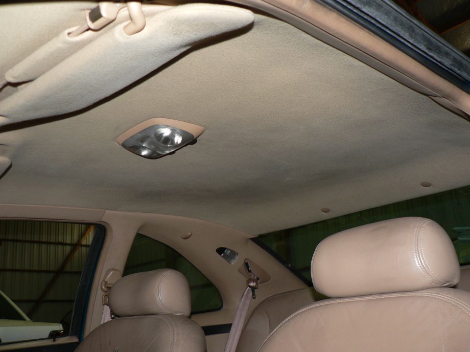 Tan headliner and rear seating area inside a car