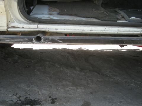 1991 Ford Bronco - This photo shows the side of a vehicle, focusing on the rock slider and the interior floor.