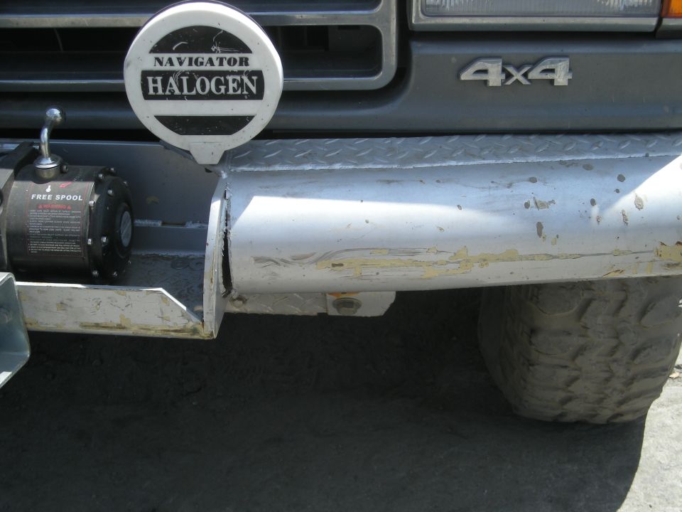 Front bumper with winch and Navigator Halogen light; 4x4 badge visible