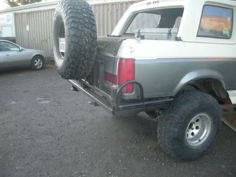 1991 Ford Bronco - This Ford Bronco features a custom rear bumper and a large spare tire mounted externally.