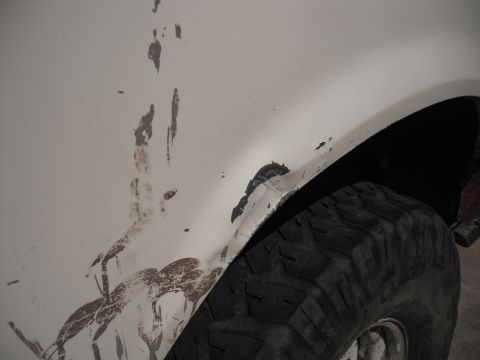 1991 Ford Bronco - Muddy fender and tire on a white vehicle, showing signs of off-road use.