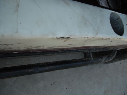1991 Ford Bronco - This image shows a portion of a vehicle's exterior, focusing on the bumper and a protective rock slider.