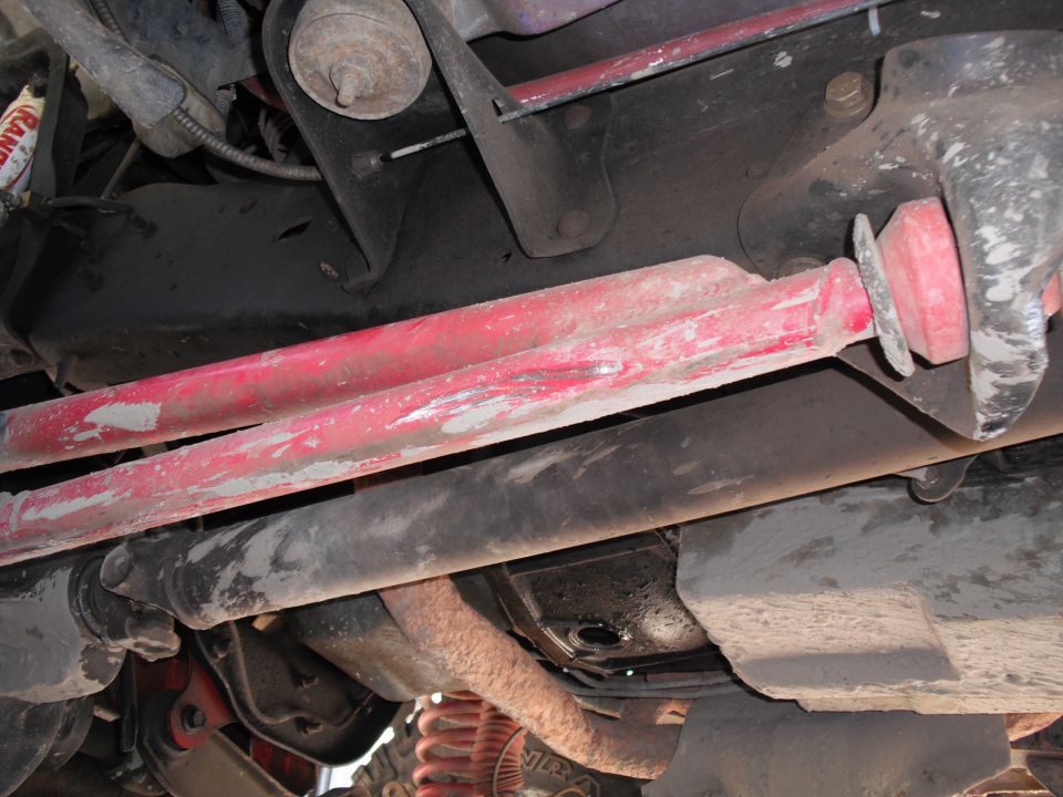 Red suspension components and underbody of a vehicle