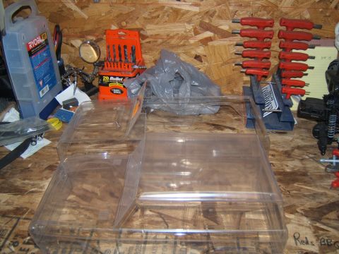 1988 Ford Bronco - Workbench setup with various tools and storage containers, including drill bits and wrenches.