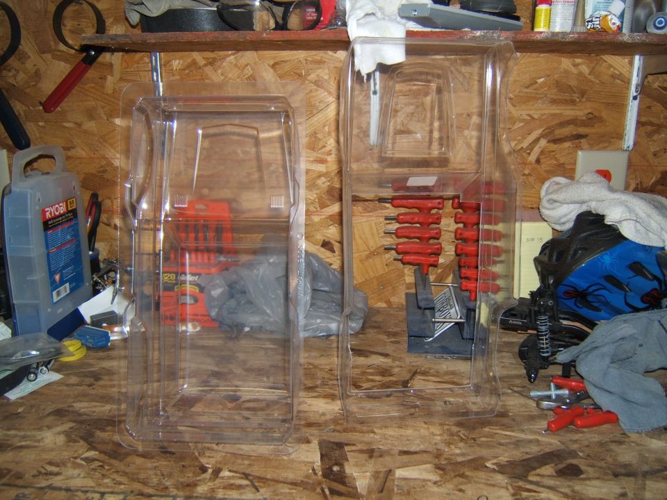 Two clear plastic packages containing RC car parts, one with red hex wrenches