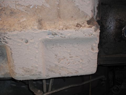 1991 Ford Bronco - Close-up view of the undercarriage of a vehicle, showing a heavily coated surface.
