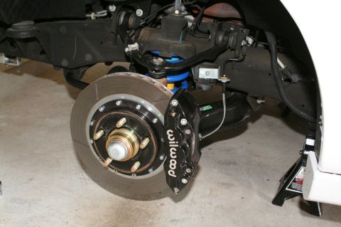 2007 Ford Mustang - Wilwood brake caliper and rotor assembly on a vehicle's rear suspension.