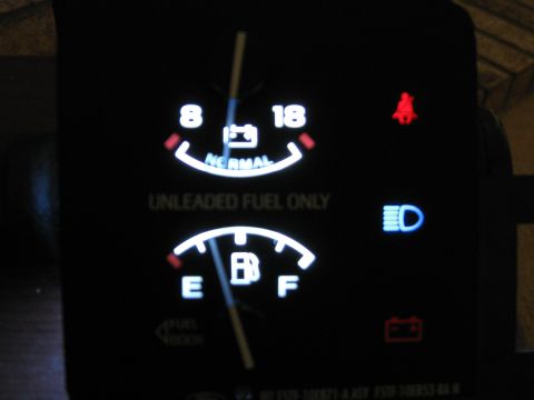 1996 Ford F-150 - Close-up of illuminated dashboard gauges showing fuel level and battery status.
