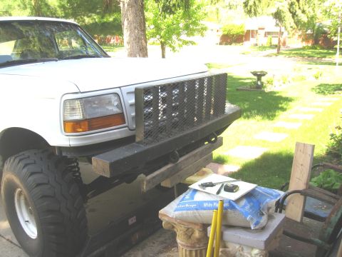 1996 Ford Bronco - Front view of a white Ford truck with a custom bumper and large tires.