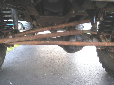 1996 Ford Bronco - Close-up of vehicle's undercarriage, focusing on steering and suspension parts.