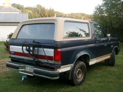 1987 Ford Bronco - Rear view of a 1987 Ford Bronco, a two-tone paint scheme and a rear-mounted spare tire carrier.