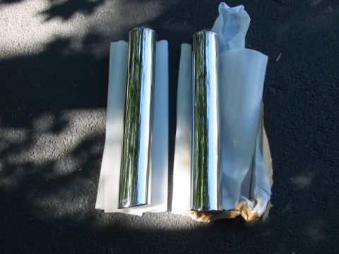 2003 Mercury Marauder - Pair of new chrome exhaust tips, likely for a performance application, shown unpackaged.