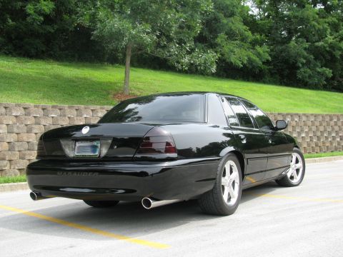 2003 Mercury Marauder - Rear view of a black 2003 Mercury Marauder with tinted taillights and aftermarket exhaust.