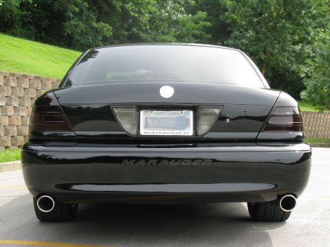 2003 Mercury Marauder - The rear of a black 2003 Mercury Marauder is shown, tinted taillights and chrome exhaust tips.