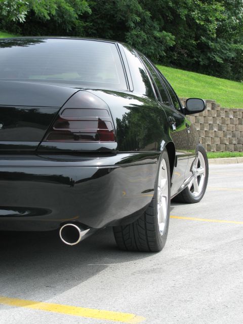 2003 Mercury Marauder - The rear passenger side of a black sedan is shown, focusing on the taillight and exhaust pipe.