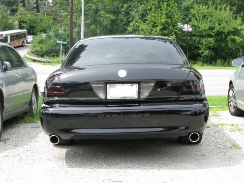 2003 Mercury Marauder - Rear view of a black sedan with tinted taillights and dual exhaust pipes, identified as a Marauder.