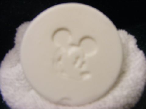 2008 Jeep Cherokee - A white disc an embossed Mickey Mouse design is shown resting on a white fabric surface.