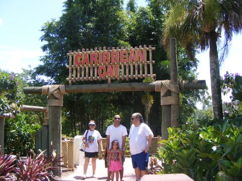 2008 Jeep Cherokee - A family poses for a photo under the Caribbean Cay sign at a tropical-themed location.