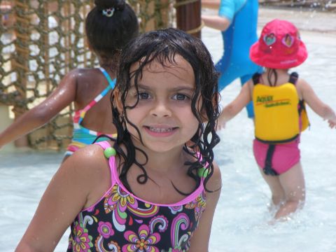 2008 Jeep Cherokee - Children enjoy a day at the water park, with one girl in the foreground smiling.