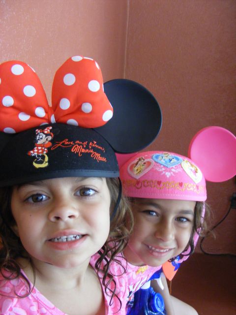 2008 Jeep Cherokee - Two smiling girls pose for a photo wearing Disney-themed hats with mouse ears.