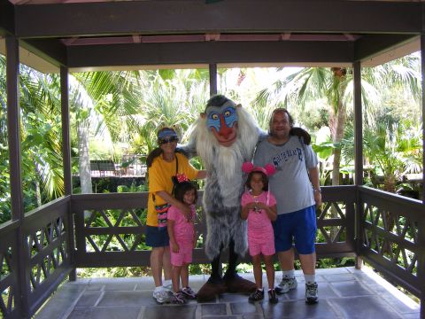 2008 Jeep Cherokee - A family poses for a photo with a character in a tropical setting.
