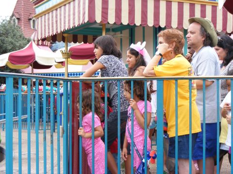 2008 Jeep Cherokee - A diverse group of people, including children and adults, wait in line at an amusement park attraction.