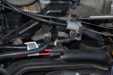 1985 Mercury Grand Marquis - Close-up view of engine components, including hoses and wiring, with a SuperMotors watermark visible.