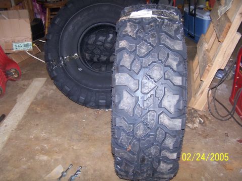 1979 Ford F-150 - A close-up view of two off-road tires, with a date stamp of 02/24/2005 visible.