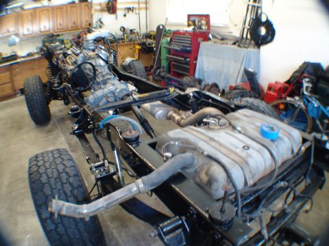 1996 Ford Bronco - The chassis of a vehicle is shown with its engine and fuel tank installed, ready for further work.