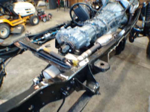 1996 Ford Bronco - Chassis and drivetrain components of a vehicle, possibly undergoing repair or rebuild.