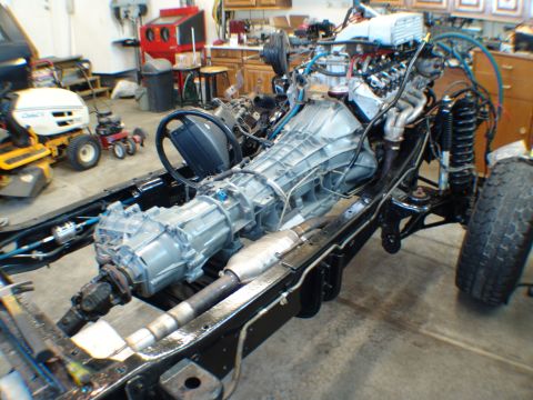 1996 Ford Bronco - The engine and drivetrain are installed in the vehicle's chassis, with the frame and suspension components clearly visible.