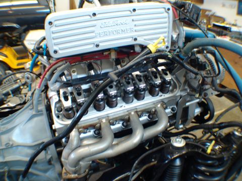 1996 Ford Bronco - Engine with Edelbrock Performer valve covers and exhaust headers, possibly undergoing rebuild.