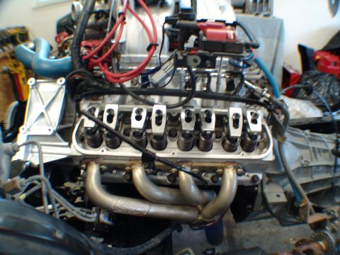 1996 Ford Bronco - Detailed view of a V8 engine's internal components, including valve springs, pushrods, and exhaust manifolds, likely during a rebuild or ma…