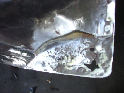 1979 Ford F-250 - This close-up shows significant rust and damage on a metal panel, indicating wear and tear.