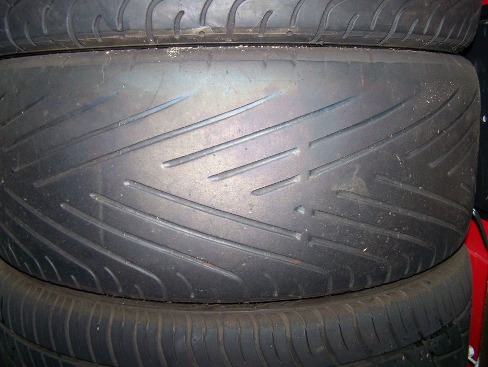 stacked tires, one with a performance tread pattern