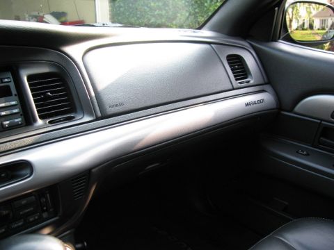 2003 Mercury Marauder - The interior dashboard of a 2003 Mercury Marauder features a prominent 'Marauder' badge on the passenger side trim.