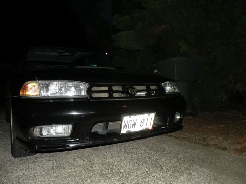 1998 Subaru Legacy - Front view of a black 1998 Subaru Legacy sedan parked outdoors at night.
