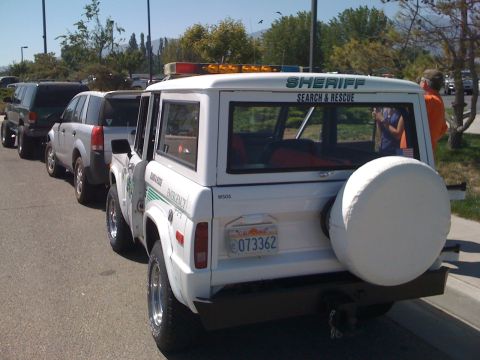 1995 Ford Bronco - A white 1995 Ford Bronco, marked as Sheriff Search & Rescue, is parked in a line with other vehicles.