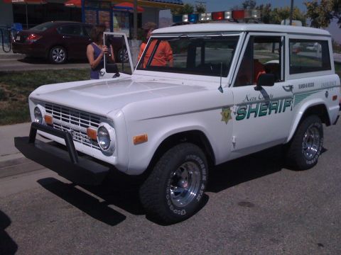 1995 Ford Bronco - This Ford Bronco is marked as a Sheriff's vehicle with 'Kersa County SHERIFF' text and emergency lights on the roof.