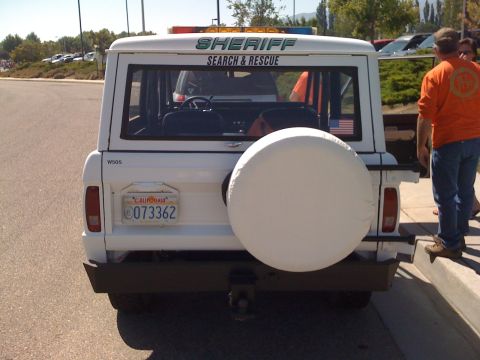 1995 Ford Bronco - This white SUV, marked 'SHERIFF SEARCH & RESCUE', is equipped with a spare tire and a California license plate.