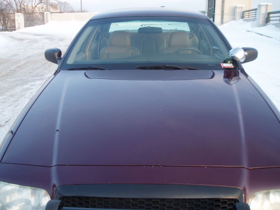 Purple sedan front view, tan interior visible, snow on ground