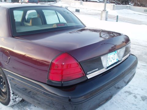 1999 Ford Crown Victoria - Rear view of a Ford Crown Victoria parked in the snow. The license plate is visible.