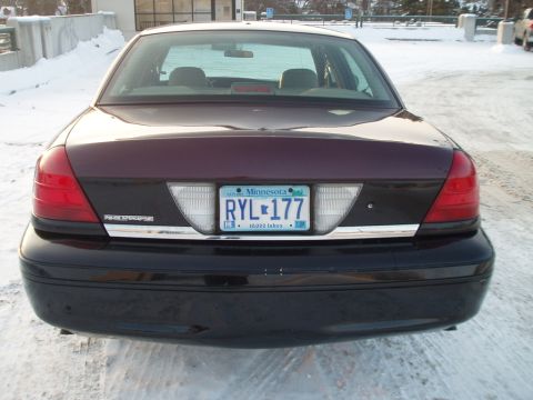 1999 Ford Crown Victoria - Rear view of a dark purple and black Ford Crown Victoria Police Interceptor parked in a snowy lot.
