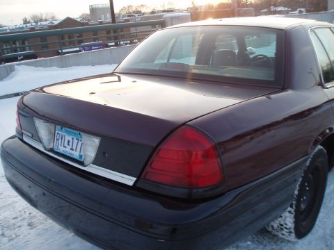 1999 Ford Crown Victoria - Rear view of a dark red 1998 Ford Crown Victoria parked in the snow.