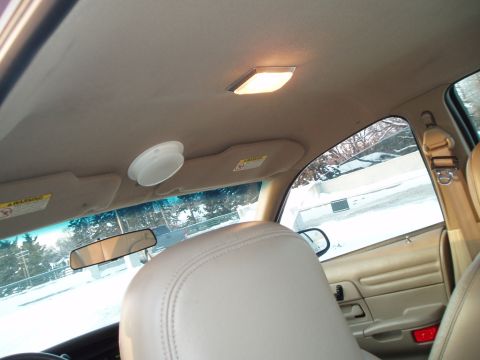 1999 Ford Crown Victoria - View from the passenger seat looking towards the front of the car, with a snowy scene visible through the windows.