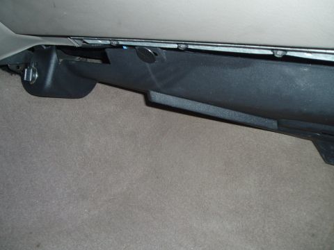 1999 Ford Crown Victoria - This photo shows a detail of a car's interior, focusing on the lower dashboard area and a power outlet.