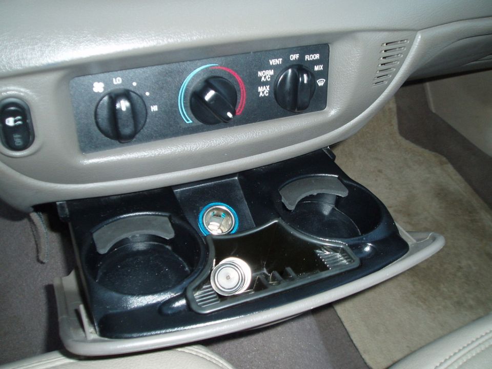 Car interior with climate controls and open cup holder compartment