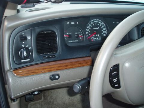 1999 Ford Crown Victoria - The dashboard shows a speedometer reading up to 120 mph and an odometer reading 132365 miles.