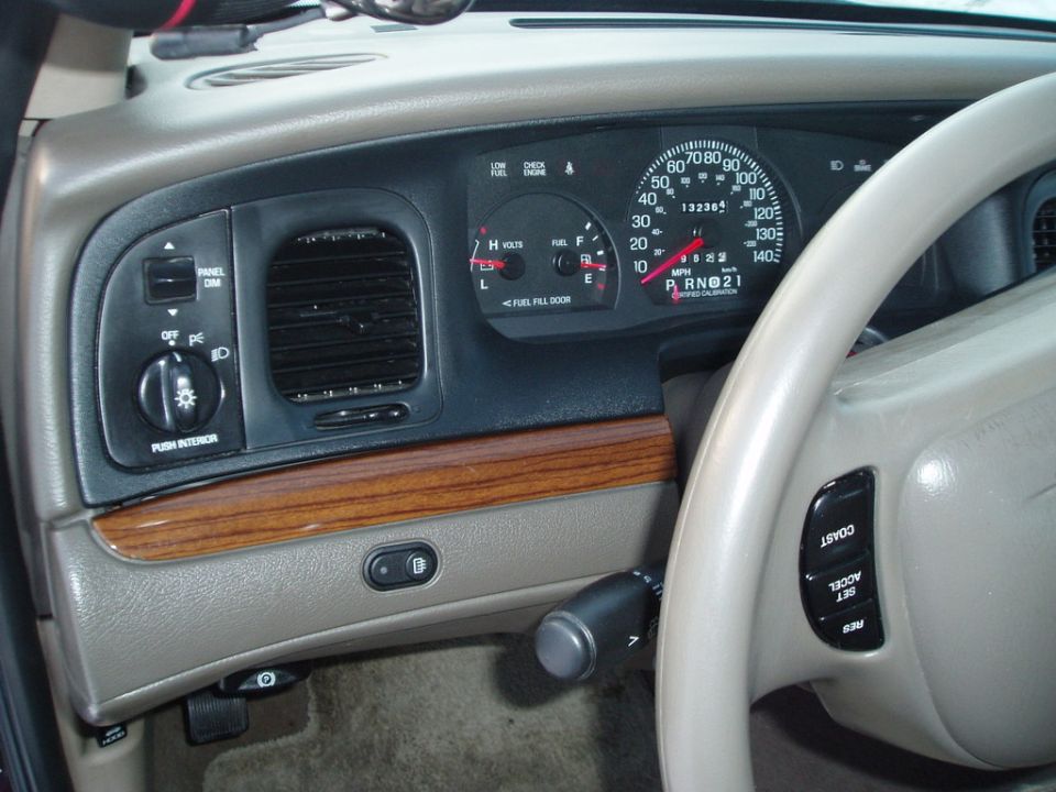 dashboard with speedometer, tachometer, fuel gauge, and steering wheel controls