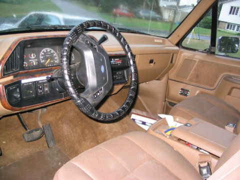1986 Ford Bronco - Interior view of a 1986 Ford Bronco, showing the dashboard, steering wheel, and seats.